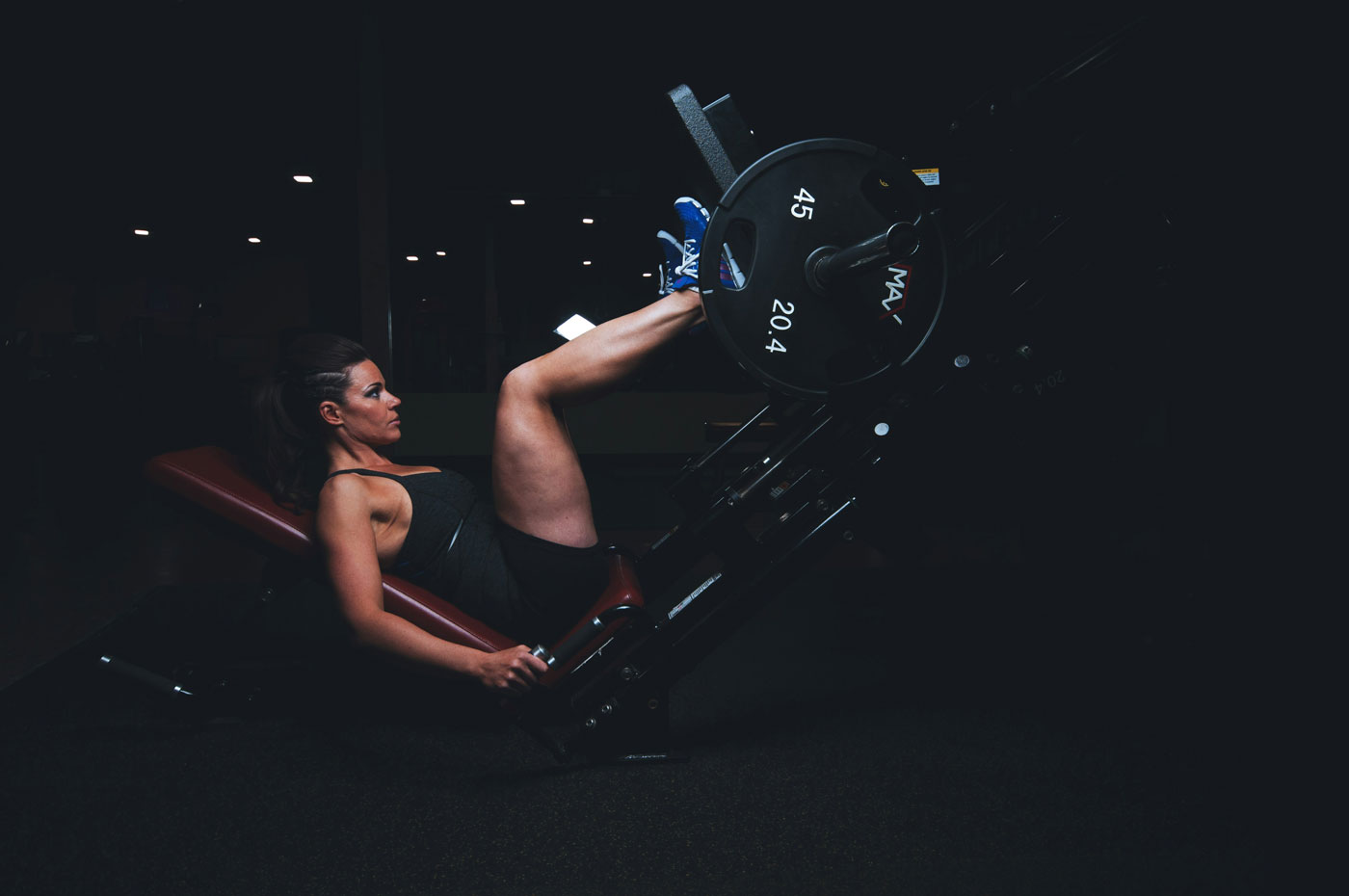 Woman training legs in the gym