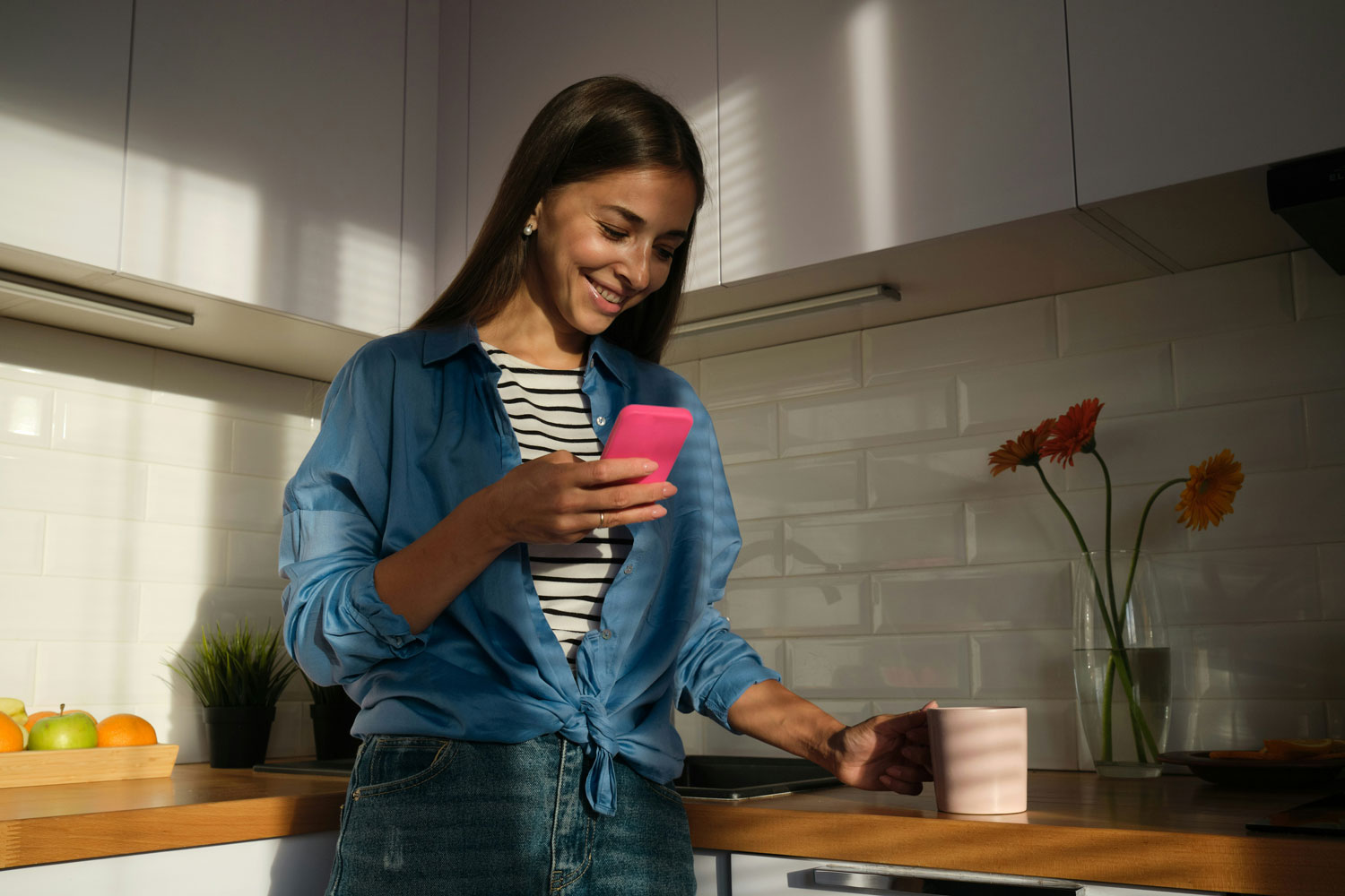 Person in a kitchen drinking a coffee