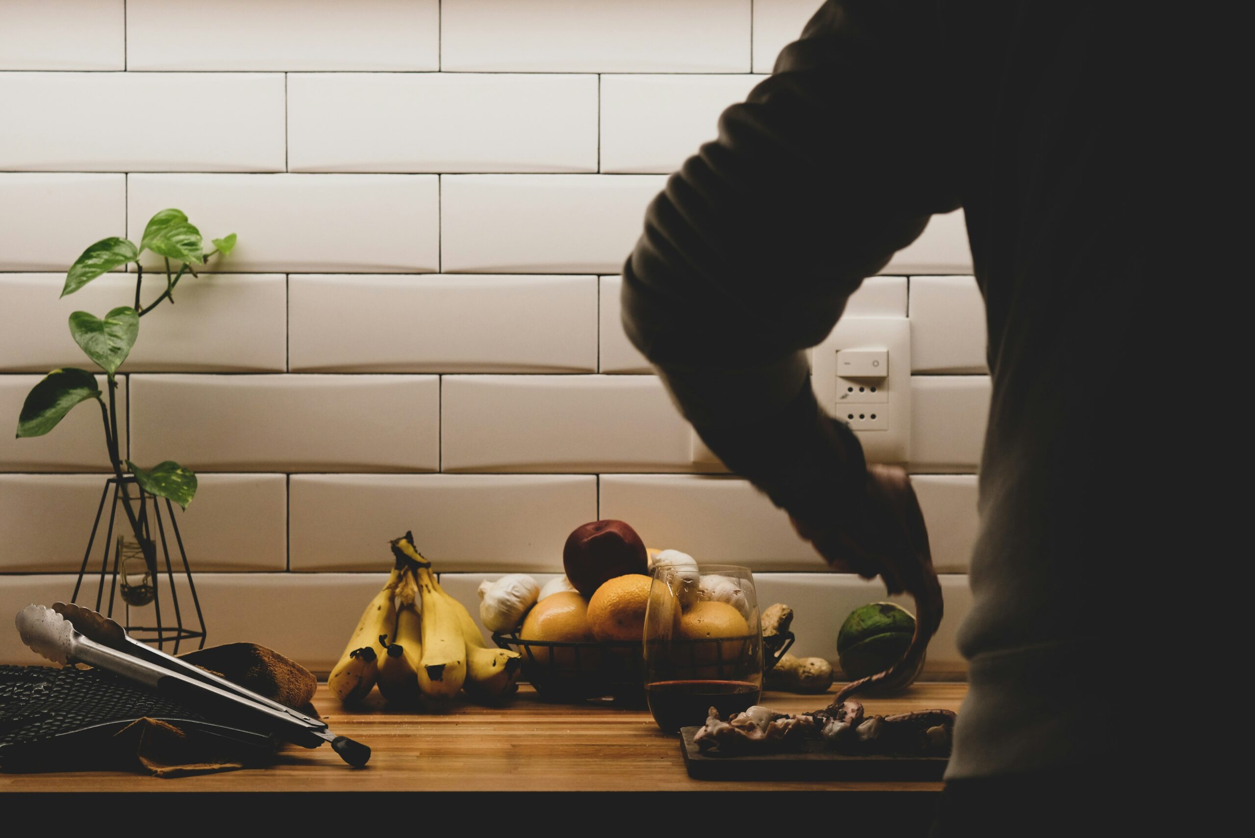 back view of person cutting vegetables on a chopping board